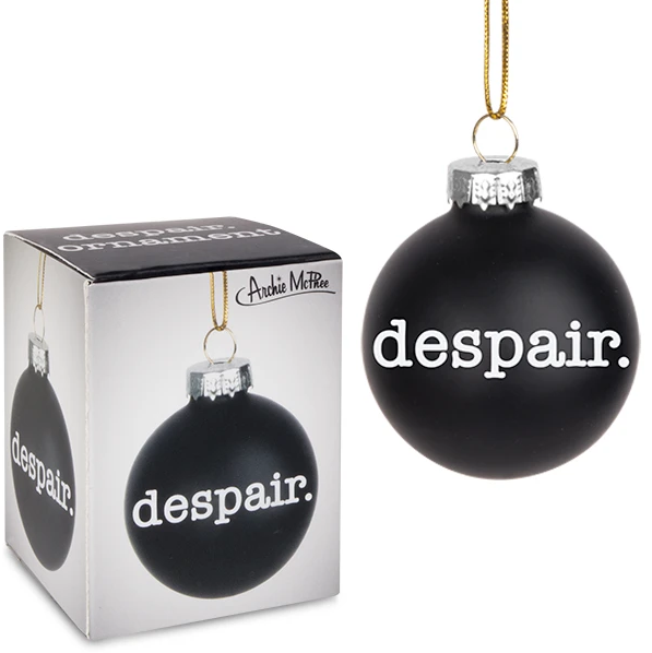 A black christmas ornament with white serif font type reading 