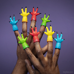 Two hands wearing one four-digit claw finger puppet on each finger. They are assorted colors including red, yellow, blue, and green.